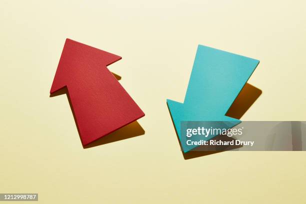 two arrows pointing in different directions - moving down stock pictures, royalty-free photos & images