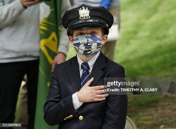 Gavin, age 10, the son of the late Glen Ridge Police officer Charles Rob Roberts, looks on during the funeral service of his father, who died of...
