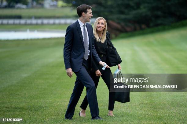 Senior Advisor Jared Kushner and White House Press Secretary Kayleigh McEnany walk to the White House on May 14 in Washington, DC after returning...