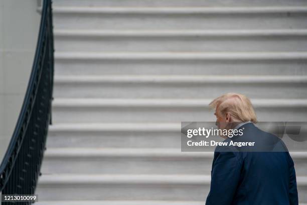 President Donald Trump walks to the White House residence after exiting Marine One on the South Lawn of the White House on May 14, 2020 in...