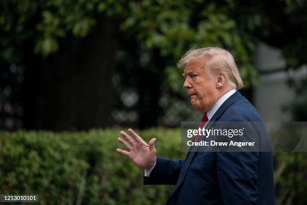 President Donald Trump walks to the White House residence after exiting Marine One on the South Lawn of the White House on May 14, 2020 in...