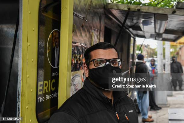 Deputy Public Advocate Kashif Hussain poses in front of a food truck providing free Halal meals for Iftar during the Muslim holy month of Ramadan in...