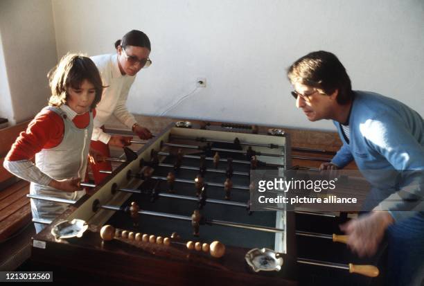Der Showmoderator Frank Elstner spielt gemeinsam mit seinem Sohn Thomas und seiner Ehefrau Sylvie in ihrem Haus in Zürs in der Schweiz Tischfußball....