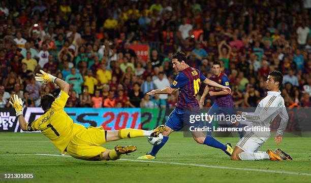 Lionel Messi of Barcelona scores past Iker Casillas of Real Madrid during the Super Cup second leg match between Barcelona and Real Madrid at Nou...
