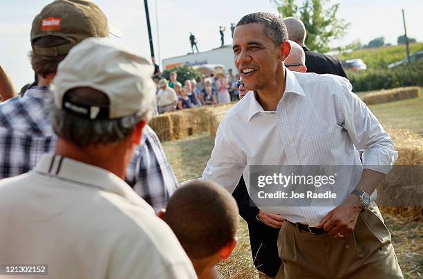 President Barack Obama shakes hands with people after speaking at a town hall style meeting at Country Corner Farm Market on August 17, 2011 in...