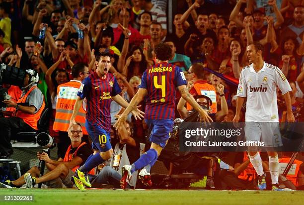 Lionel Messi of Barcelona celebrates the winning goal with Cesc Fabregas during the Super Cup second leg match between Barcelona and Real Madrid at...