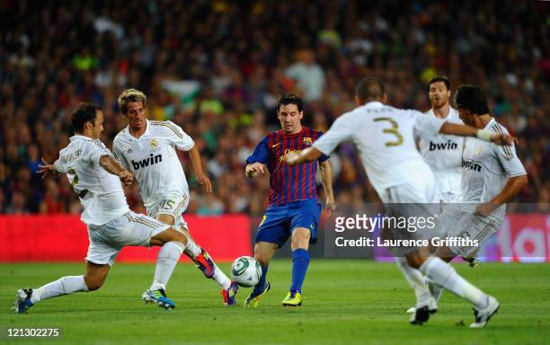 Lionel Messi of Messi of Barcelona is the centre of attention during the Super Cup second leg match between Barcelona and Real Madrid at Nou Camp on...