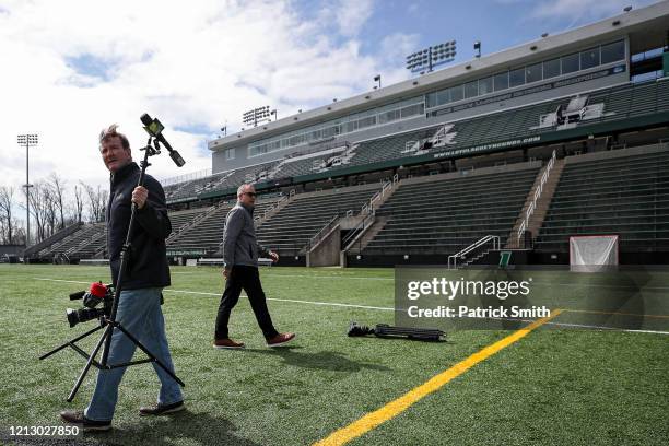 Prior to an interview, WBAL Chief Sports Photographer Jim Forner carries a microphone connected to a light-stand in an effort to practice proper...