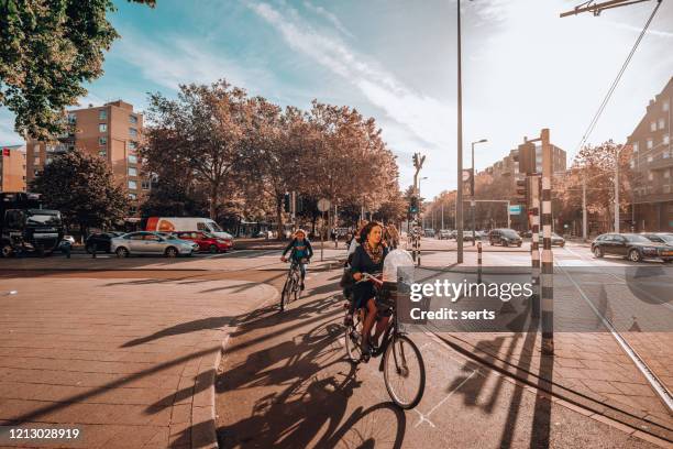 cycling in in rotterdam, netherlands - netherlands bike stock pictures, royalty-free photos & images
