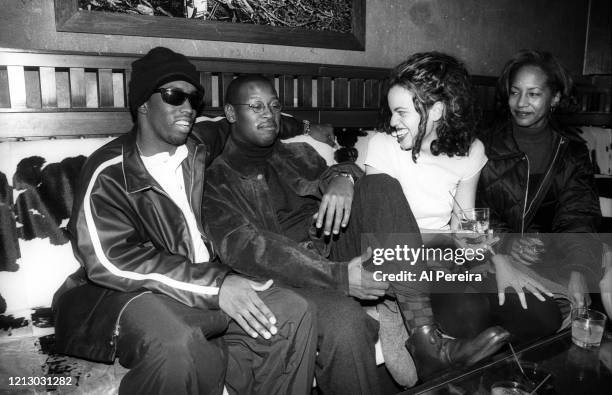 Hip-Hop Producer/Executive/Label Head Andre Harrell relaxes in a nightclub VIP area by chatting with Sean "Puffy" Combs, record label executive...