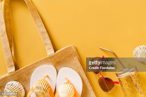 summer beach bag made of rough linen canvas and women's slates with shells - beach flat lay stock pictures, royalty-free photos & images