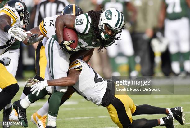 Chris Ivory of the New York Jets gets tackled by William Gay and Lawrence Timmons of the Pittsburgh Steelers during an NFL football game November 9,...