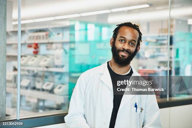 portrait of smiling scientist in research lab - black lab bildbanksfoton och bilder