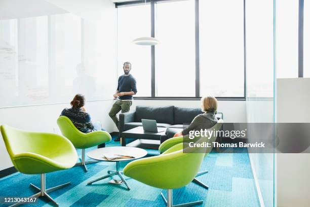 colleagues working on project on whiteboard in conference room - scientist standing next to table stock-fotos und bilder