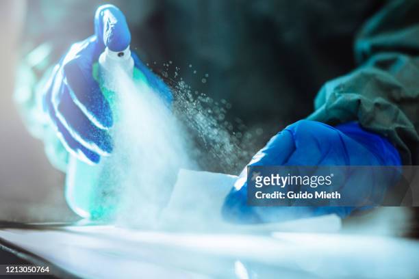 spraying disinfection on surface. - abbigliamento da lavoro foto e immagini stock