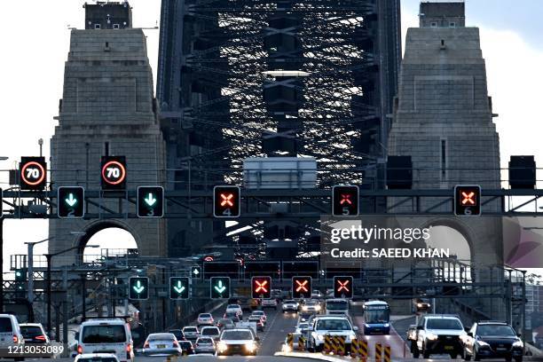 Early morning traffic is seen on the Harbour Bridge in Sydney on May 15, 2020. - The New South Wales state relaxed COVID-19 restrictions around...