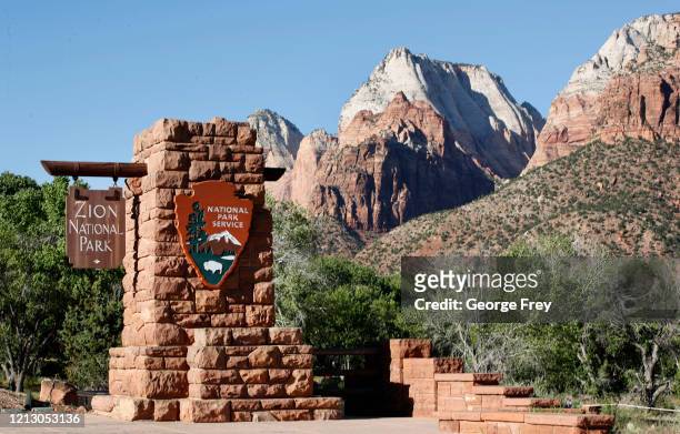 Sign hangs at the entrance to Zion National Park on May 14, 2020 in Springdale, Utah. Zion National Park had a limited reopening yesterday as part of...