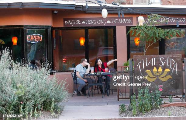 Two dinners sit outside the mostly empty Thai Sapa restaurant on May 14, 2020 in Springdale, Utah. Springdale is where the entrance to Zion National...