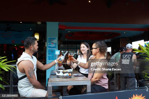 People eat and drink as they sit at Monsoons Bar on Mitchell st on May 15, 2020 in Darwin, Australia. Restrictions across the Northern Territory will...