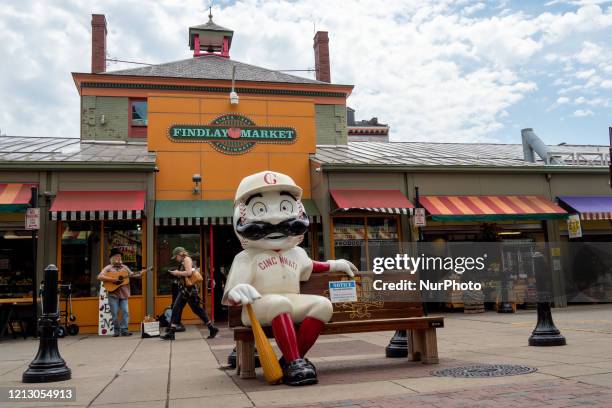 Street performer at Findlay Market plays the guitar for passing customers as businesses begin to reopen in the wake of the Coronavirus COVID-19...