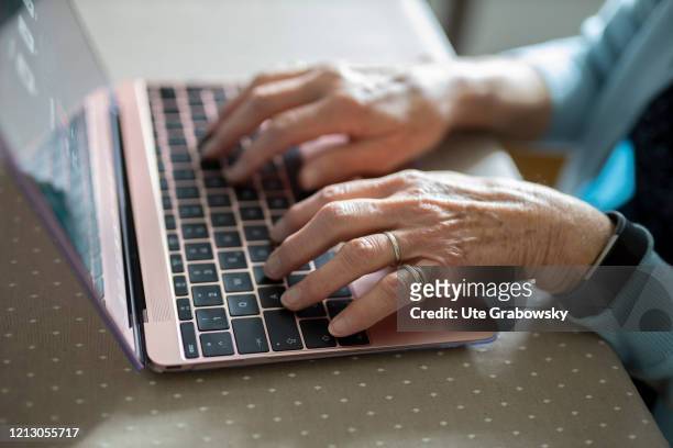 In this photo illustration old hand are working on a laptop an old woman is using a laptop on May 12, 2020 in Radevormwald, Germany.