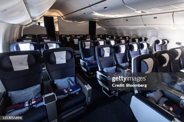 Empty passenger seats sit in the Business Class cabin on board a British Airways flight from London to Hong Kong, on Wednesday, May 13, 2020. As...