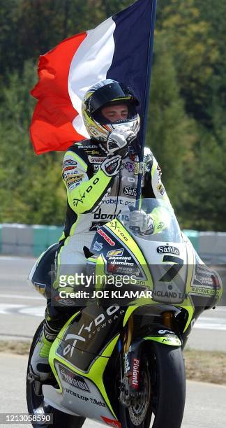 Randy De Puniet of France on Aprilia takes a winners lap with his flag as he won the 250cc Czech Grand Prix in Brno on 17 August 2003. AFP PHOTO JOE...