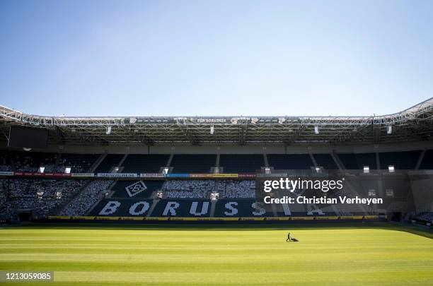 Greenkeeper of Borussia Moenchengladbach prepares the pitch of Borussia-Park on May 15, 2020 in Moenchengladbach, Germany.