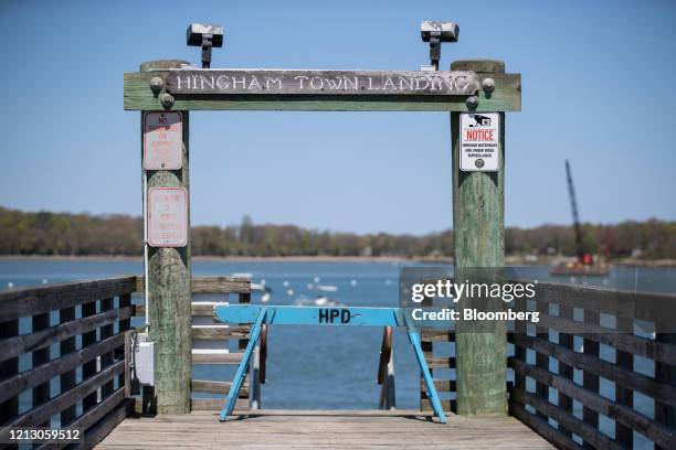 Police barricade blocks access to a public boat landing in Hingham, Massachusetts, U.S., on Thursday, May 14, 2020. With boating season historically...