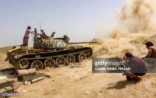 Tank belonging to forces loyal to Yemen's Southern Transitional Council separatists fires while on the frontline of clashes with pro-government...