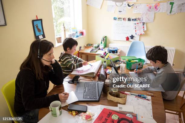 Six-year-old Leo and his three-year old brother Espen complete homeschooling activities suggested by the online learning website of their infant...