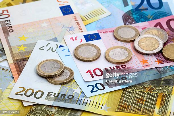 variety of denominations of euro coins and bills - banknote stock pictures, royalty-free photos & images