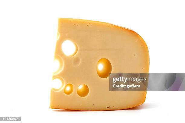 a piece of yellow cheese by itself - gat stockfoto's en -beelden