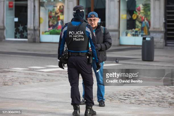 Police ask citizens for documentation on Sol Square on the second working day of the state of alarm, patrol Puerta del Sol on March 17, 2020 in...