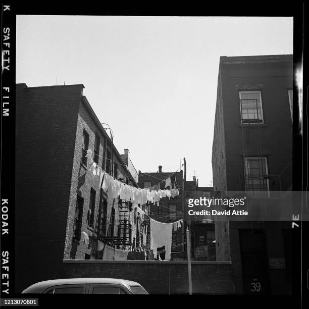 Clothes hang on a clothesline next to P.C. Herwig Co. Square Knotting Design, in Brooklyn Heights, in March 1958 in New York City, New York.