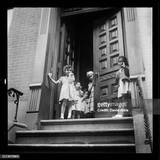Young girls stand on a stoop in Brooklyn Heights, in March 1958 in New York City, New York.