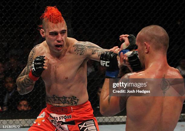 Dan Hardy punches Chris Lytle during a welterweight bout at the UFC on Versus 5 event at the Bradley Center on August 14, 2011 in Milwaukee,...