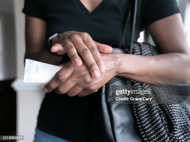 woman lotions hands - handkräm bildbanksfoton och bilder