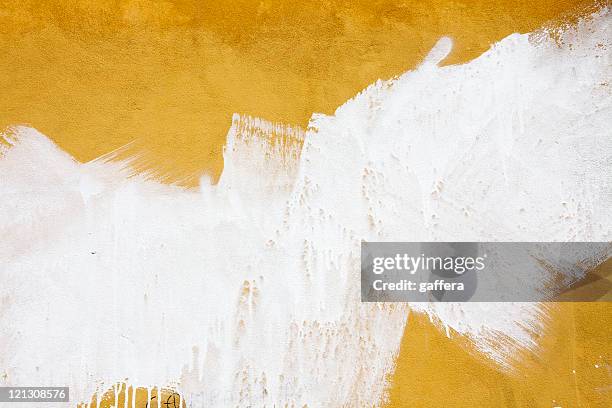 a yellow wall splashed with white paint - textured wall stock pictures, royalty-free photos & images
