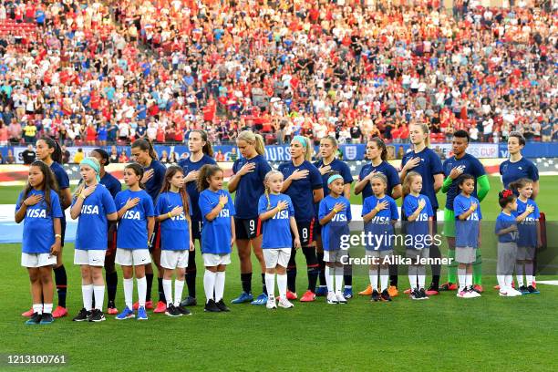 The United States women's national team stand during the national anthem with their tops turned inside out as part of the team's equal pay campaign...