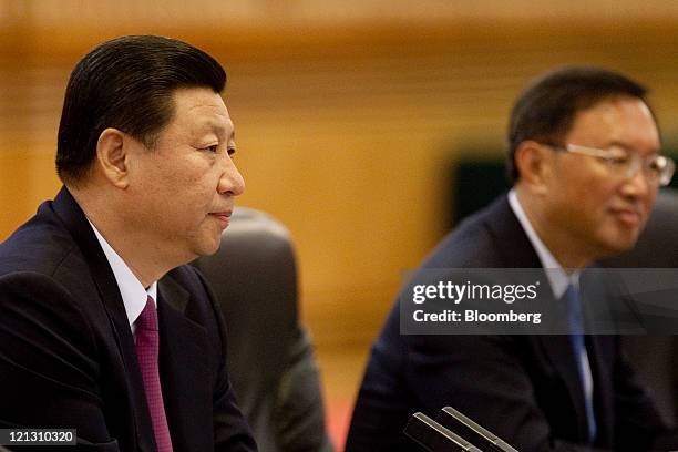 Xi Jinping, China's vice president, left, and Yang Jiechi, China's foreign minister, hold a bilateral meeting with Joe Biden, U.S. Vice president,...