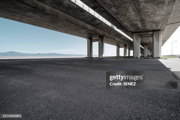 empty pavement under highway bridges - viaduct ストックフォトと画像