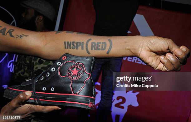 Celebrity Activist and Runner Suzanne "Africa" Engo holds up the RED AIDS Awareness Shoe from Converse at the MTV2 Band of Ballers Preview Party on...