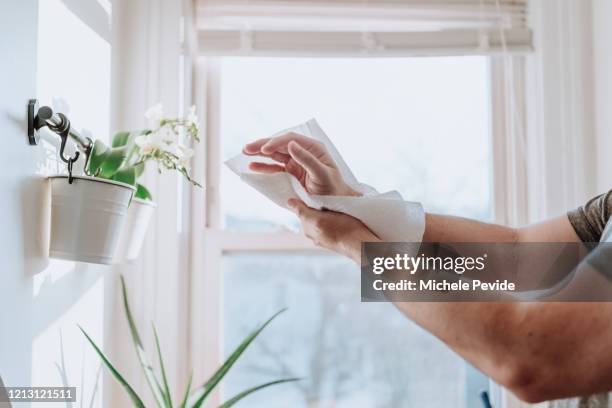 person drying hands with paper towels to prevent disease dissemination, covid-19 - drying stock pictures, royalty-free photos & images