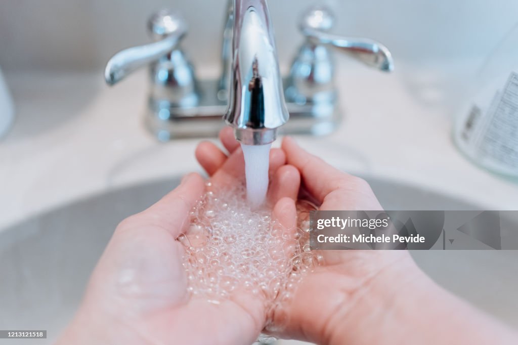 Person washing hands to prevent contagious disease