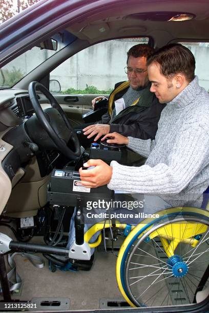 Fahrlehrer Dietmar Larm erklärt am 8.11.1999 einem Rollstuhlfahrer die Bedienungselemente eines von der Polcher Firma Rolli-Cars behindertengerecht...
