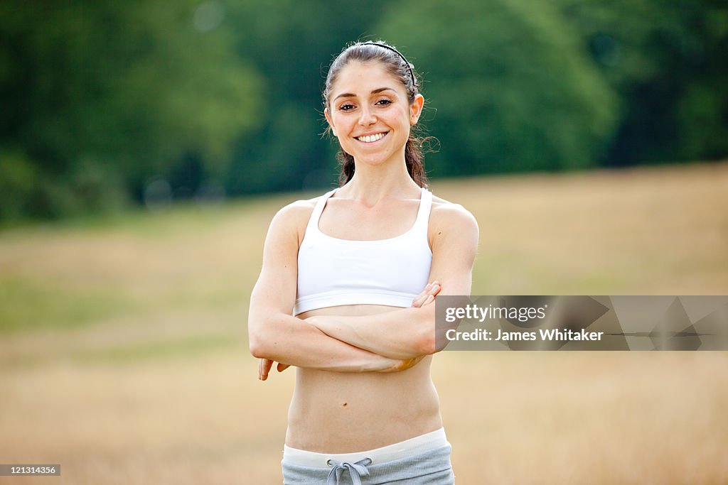 Happy Female Runner in Meadow