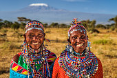 Portrait of happy African women, Mount Kilimanjaro on the background, Kenya, East Africa