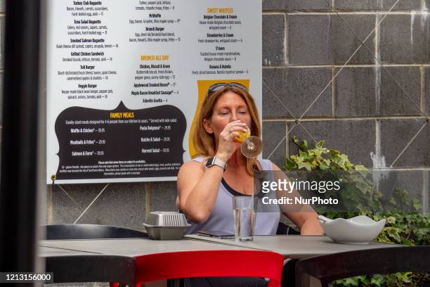 Taste of Belgium customer enjoys a drink outside as businesses begin to reopen in the wake of the Coronavirus COVID-19 pandemic, Friday, May 15 in...
