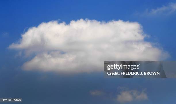 An airline clears a layer of pollution hovering over Los Angeles, for the blue sky above on May 15, 2020. - The Airline and travel industries have...